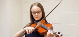 An image of a girl playing a violin.
